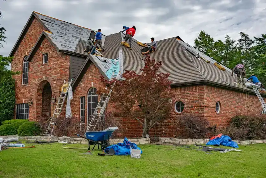 roofers installing gutter guards on a brick home eavestrough in Barrie roofers installing gutter guards on a brick home eavestrough in Barrie